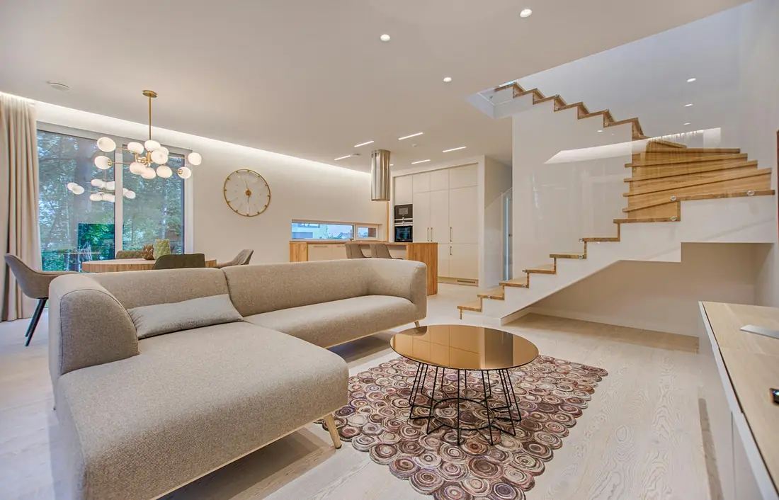 Bright living room with a finished ceiling and floating staircase