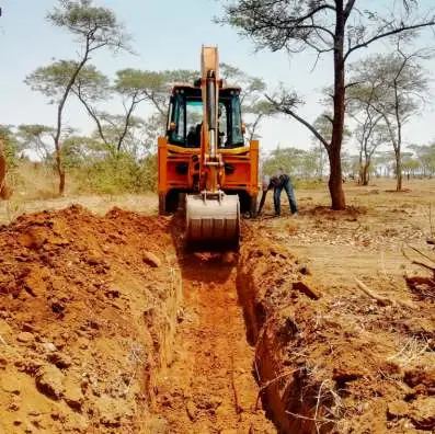 Backhoe digging a foundation trench