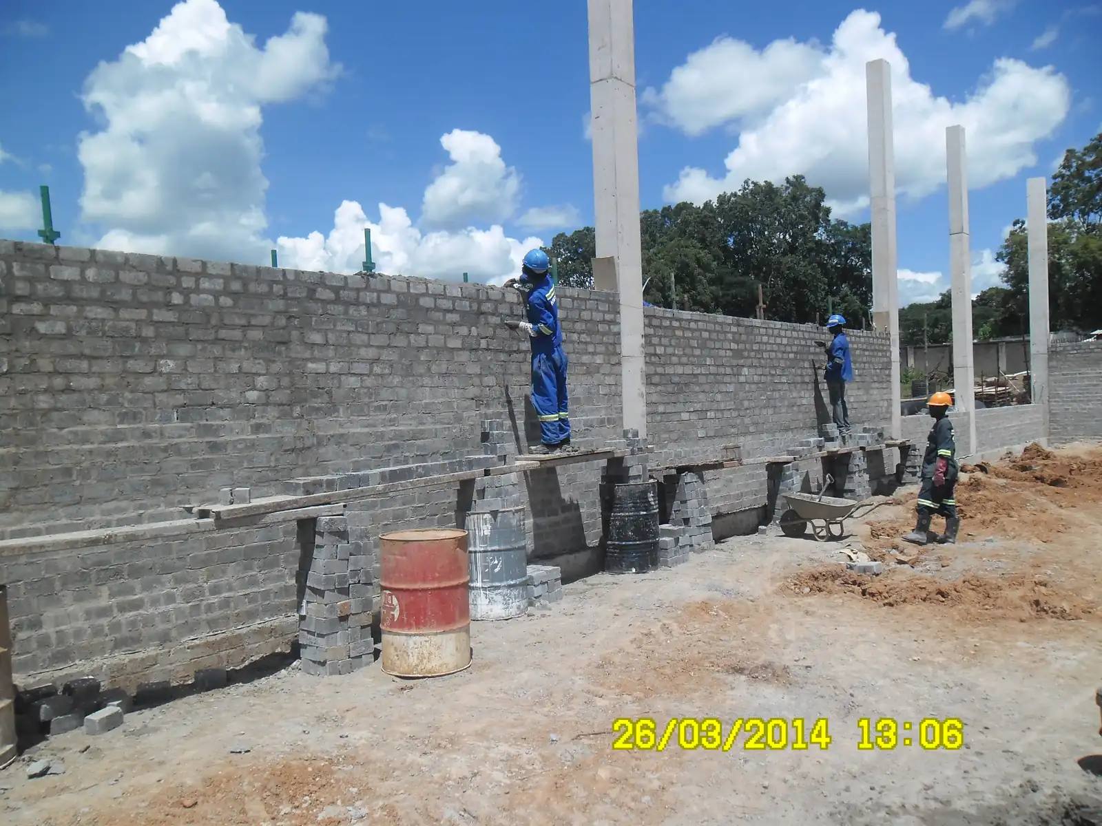 MK Production bricklayers building walls between concrete columns
